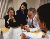 Picture of a group discussing design plans.