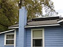 blue house with solar panel on roof