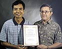 photo of Dr. Huang and Dr. T-Raissi holding certificate