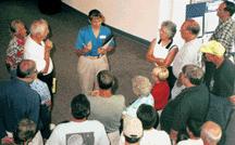 Photo of Mary Huggins talking to visitors.