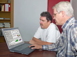 Philip Fairy and Brian Hanson looking at EnergyGauge software on laptop computer