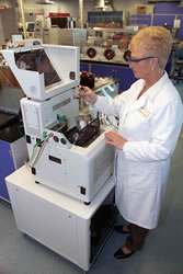 Photo of researcher using lab equipment.