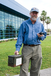 Photo of Bill Young holding box and gps unit.